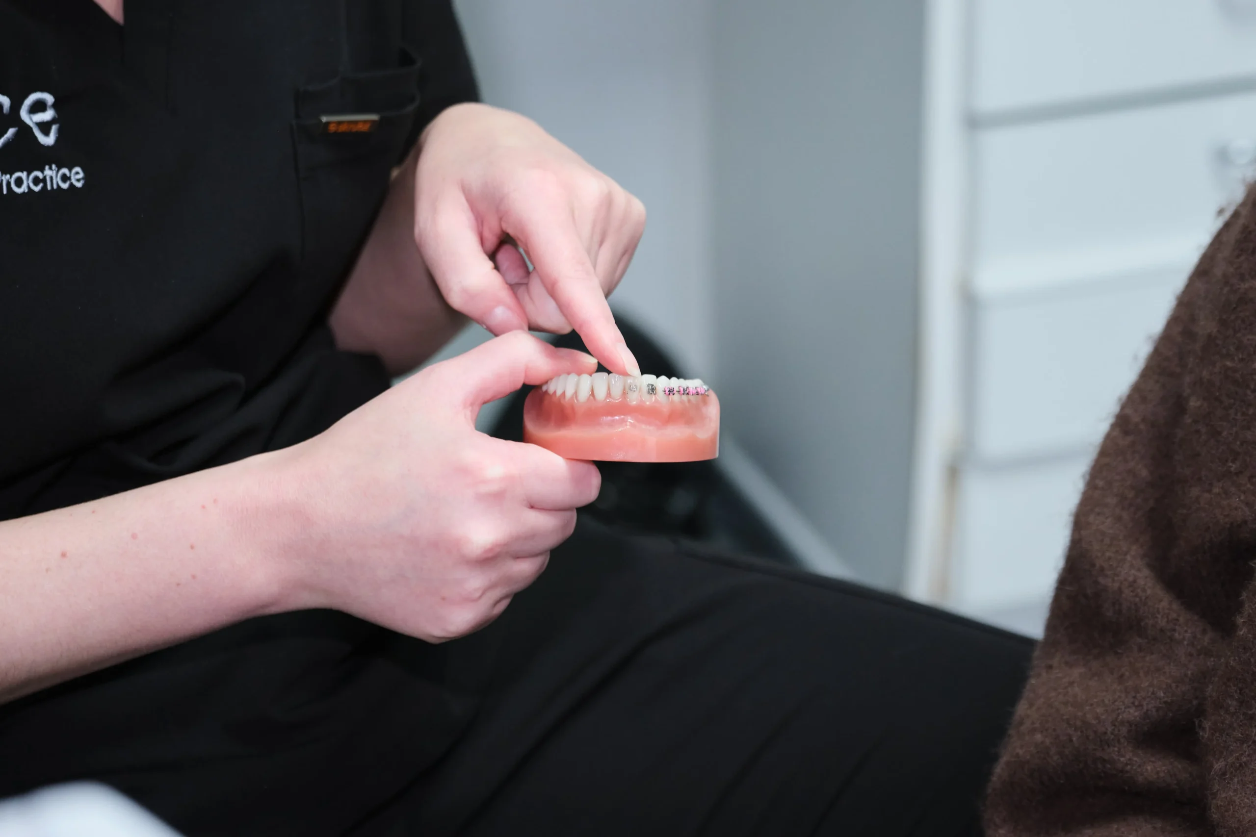 Dentist explaining fixed braces